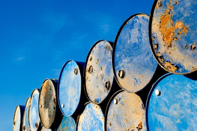 Rusty metal barrels stacked in rows