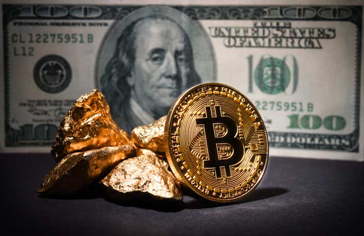 Bitcoin and gold nuggets on dollars