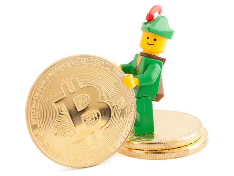 Robin Hood (as Lego figure) standing next to Bitcoin coins, January 07, 2018 in Venice, Italy