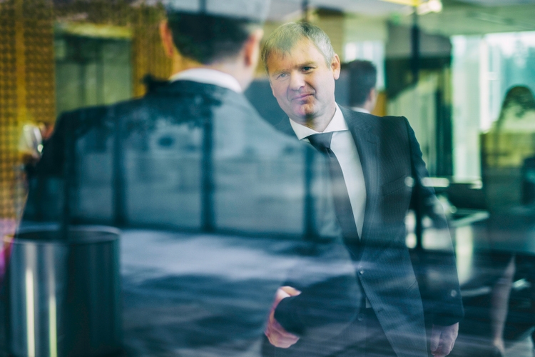 Businessmen shaking hands in an office lobby