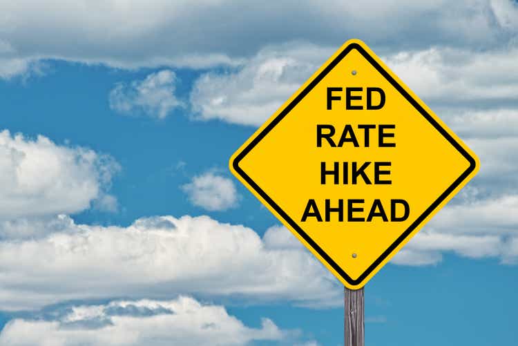 Fed Rate Hike Ahead - Caution Sign Blue Sky Background