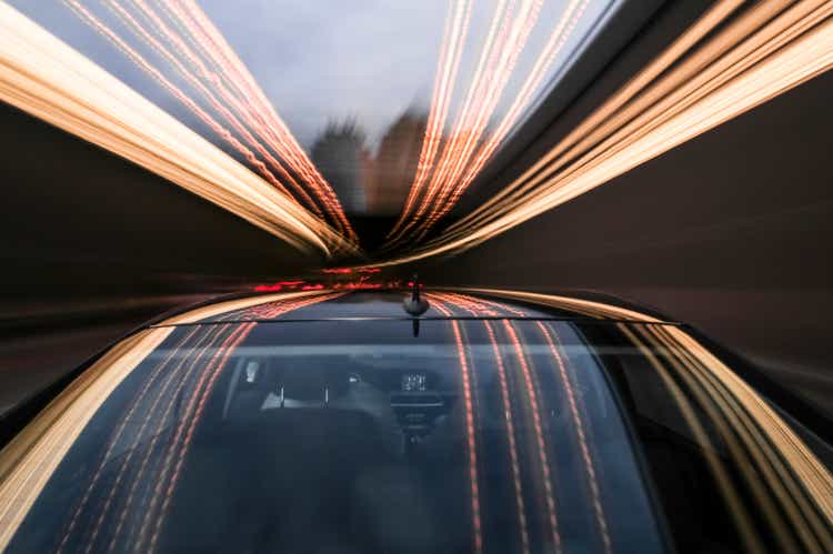 driving black German car with reflections and the rear window in foreground