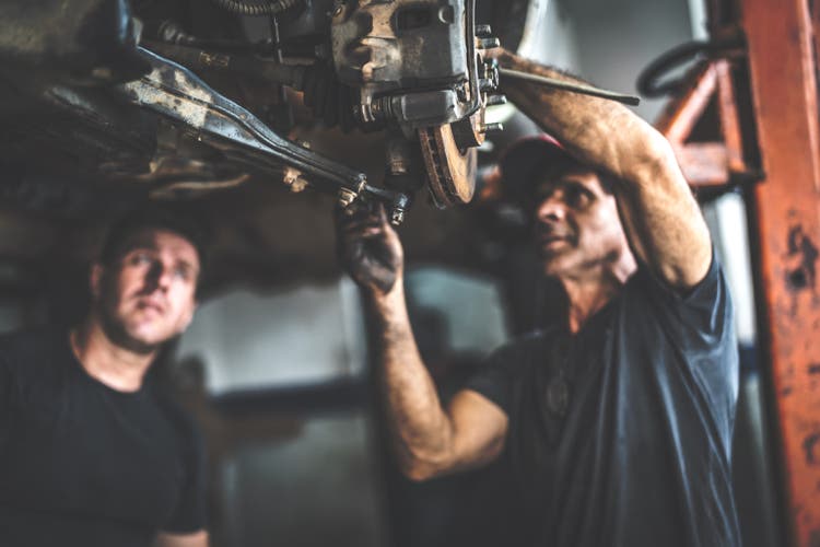 Professional mechanic repairing a car in auto repair shop