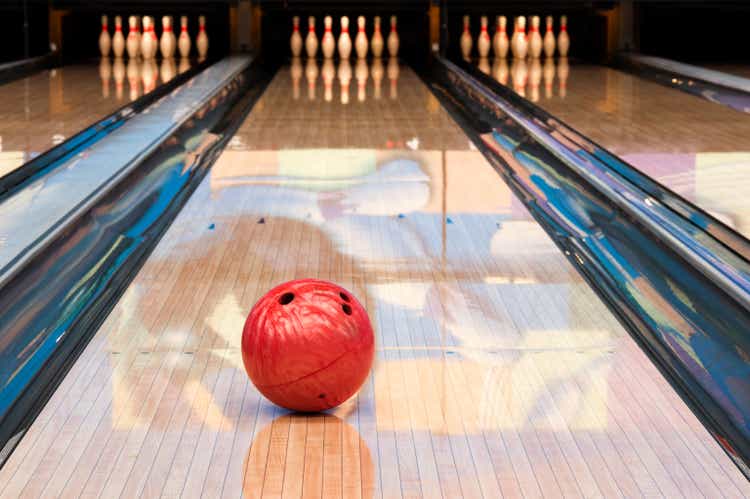 Red bowling shot sitting successful mediate of recently oiled lane