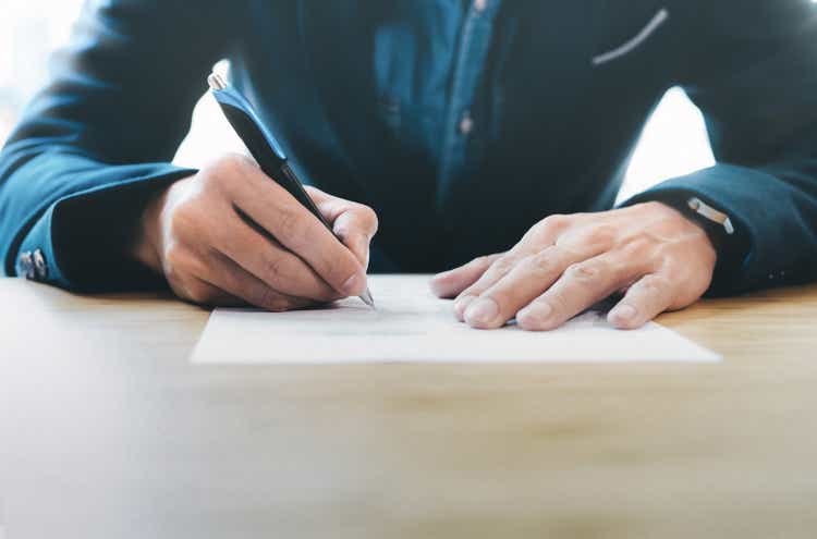 Businessman signing contract making a deal.