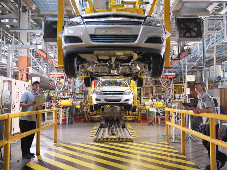 Car Workers Inspecting Production Line