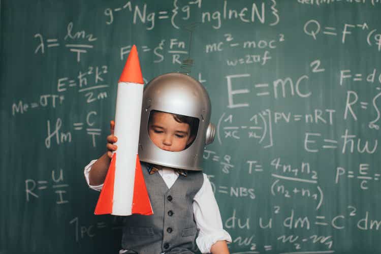 Young businessman with space helmet and rocket