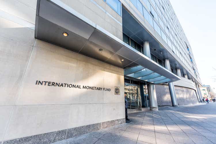 IMF entrance with International Monetary Fund sign, security guard doors on wall of concrete architectural building