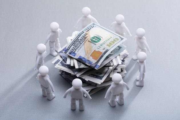 Stacked Banknotes Surrounded By Human Figures