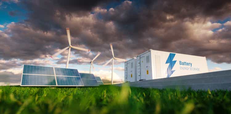 Concept of energy storage system. Renewable energy - photovoltaics, wind turbines and Li-ion battery container in fresh nature. 3d rendering.