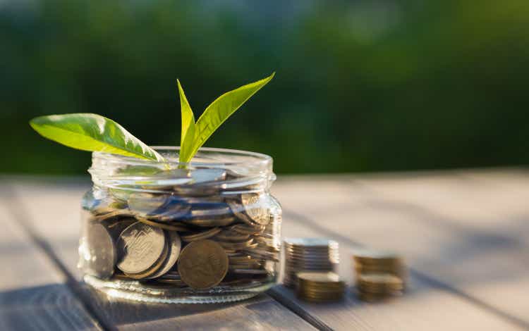 Growth of income and business. Glass jar with coins