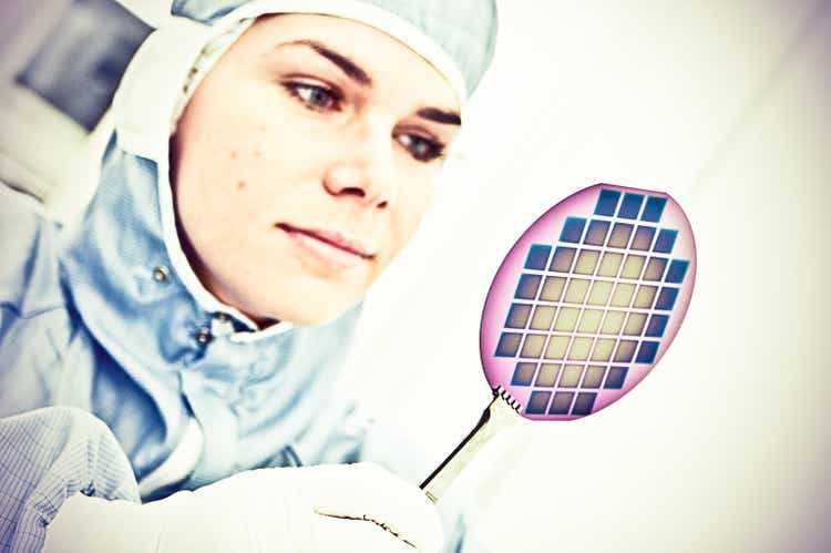 Female Scientist Carefully Inspect A Silicon with Square Pixel Detectors