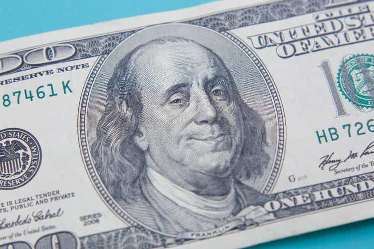 US hundred dollar bill with smiling and winking Benjamin Frankli