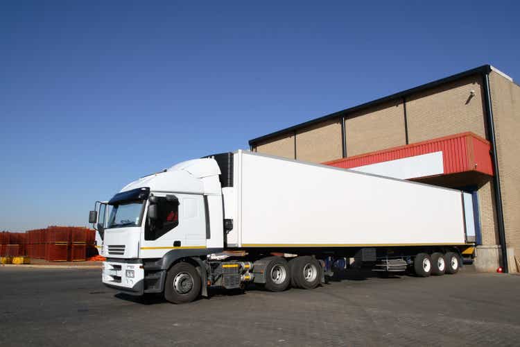 Semi truck at storage warehouse .