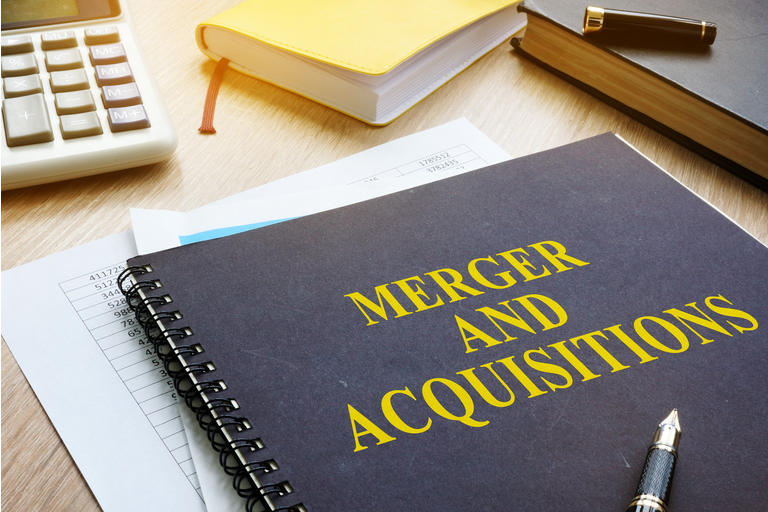 Book about Merger And Acquisitions M&A on a desk.
