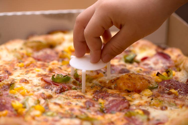 Child Hand Taking A Slice Of Pizza