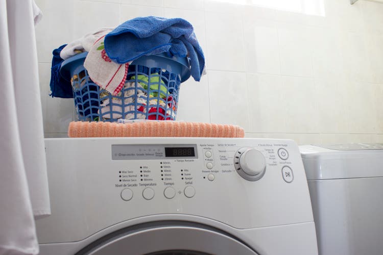 Clean laundry basket over the washing machine. Low level angle.