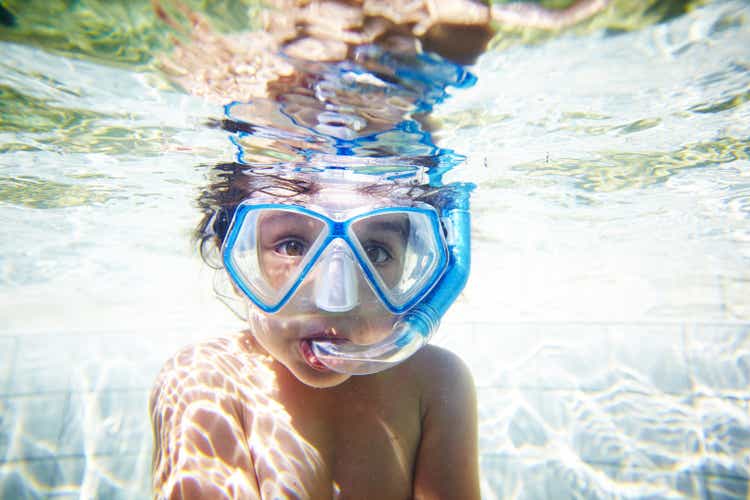 Girl with snorkel in pool, underwater view