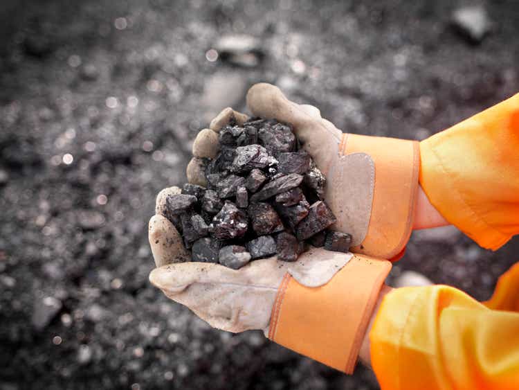 Coal Worker With Handful Of Coal