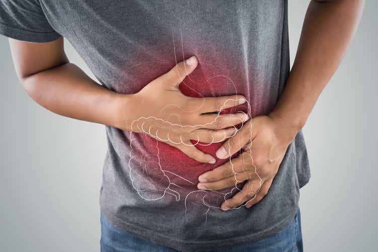 The photo of large intestine is on the man"s body against gray background, People With Stomach ache problem concept, Male anatomy