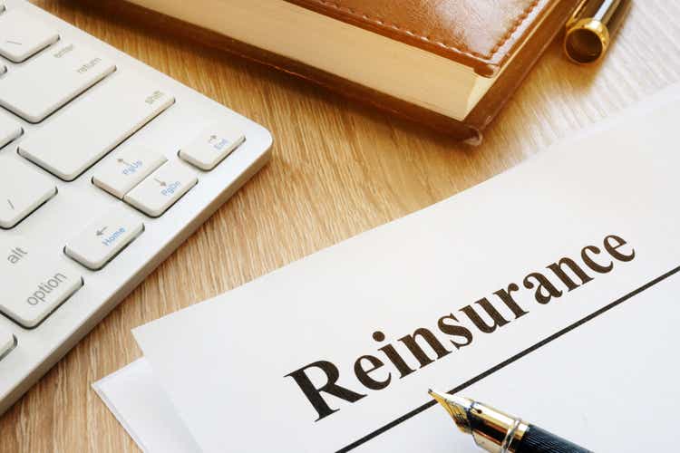 Documents with title reinsurance on a desk.