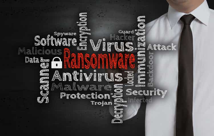Ransomware wordcloud is written by businessman on screen