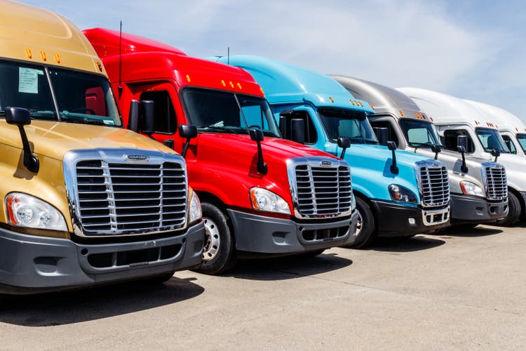 Colorful Freightliner Semi Tractor Trailer Trucks Lined up for Sale. Freighliner is owned by Dailmer Trucks IV