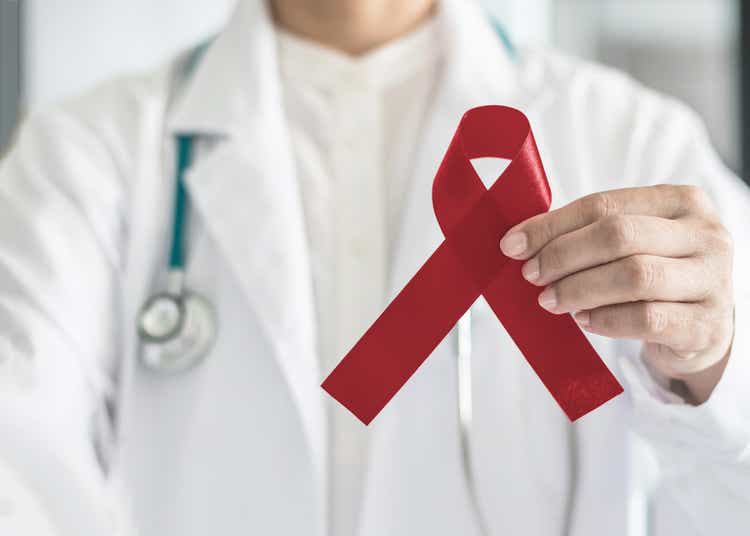 Burgundy ribbon awareness in doctor hand for multiple myeloma cancer, adults with disabilities awareness & support, headaches migraines and Sickle-Cell Anemia,