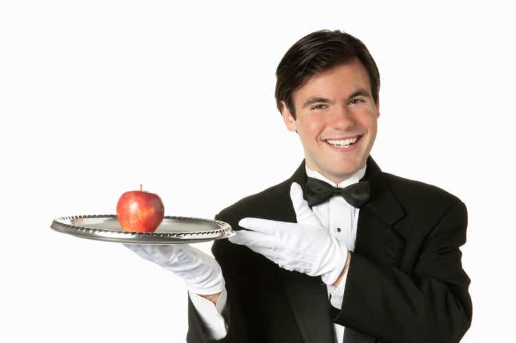 man holding silver tray with apple