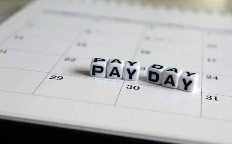 A white cube arranged in the word 'PAY DAY " on the calendar.