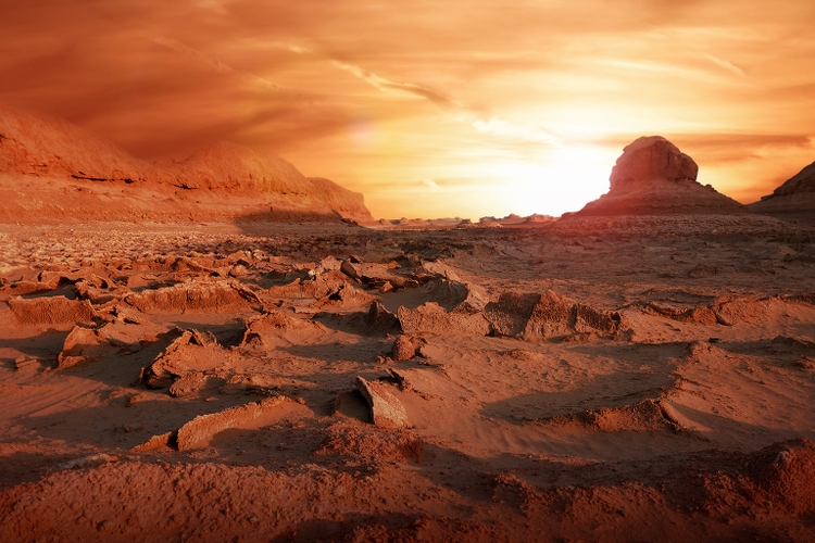 Dry soil in the desert. Extreme heat. Climate change. Landscape in red and yellow tones.