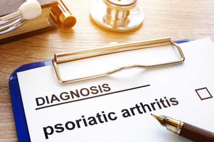 Diagnosis psoriatic arthritis and clipboard on a desk.