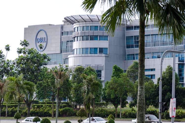 Exterior view of Dell Technologies office building, on street with palm and green trees.