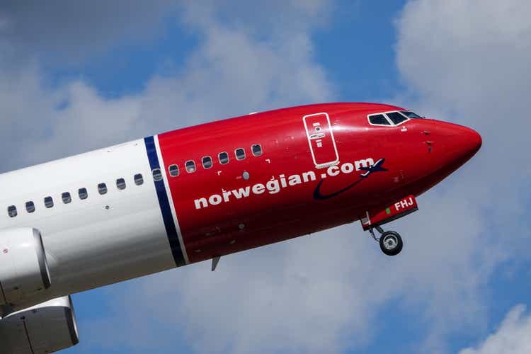 Norwegian Air Shuttle ASA, Boeing 737 - 800 take off in white clouds and blue sky at Stockholm Arlanda Airport / ARN. Jet aircraft / plane.