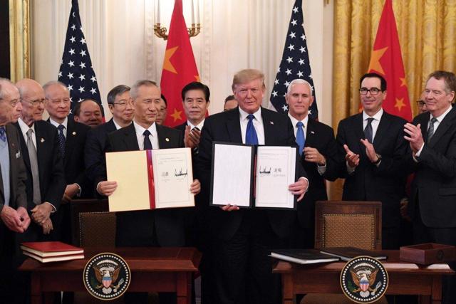 Chinese Vice-Premier Liu He and US President Donald Trump display the signed phase one US-China trade agreement at the White House in Washington on Wednesday. Photo: AFP