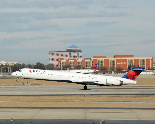 A Delta Air Lines MD-90 landing on a runway