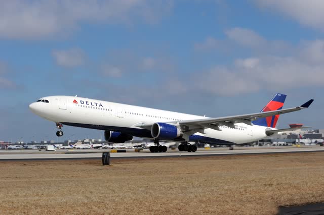 A Delta Air Lines plane landing on a runway