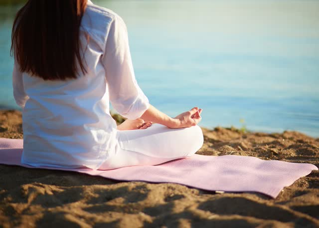 A person sitting on the beach Description automatically generated with medium confidence