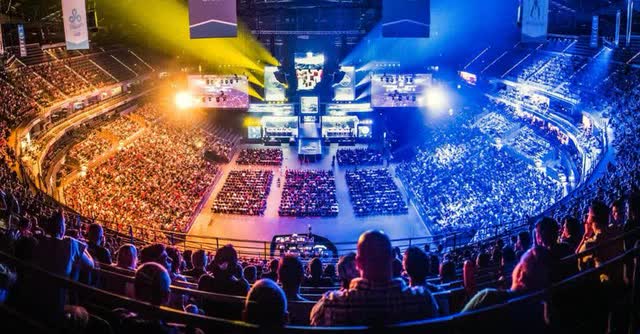 a large stadium showcasing thousands watching an esports event live
