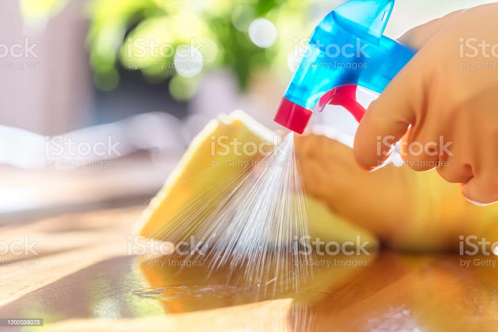 Cleaning with spray detergent, rubber gloves and dish cloth on work surface Cleaning with spray detergent, rubber gloves and dish cloth on work surface concept for hygiene Cleaning Stock Photo