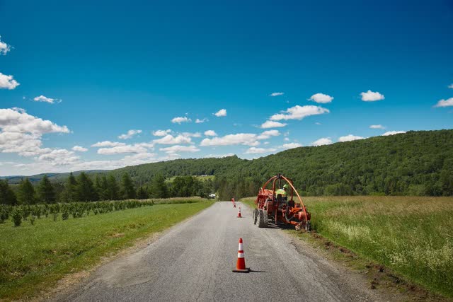 A tractor on a road Description automatically generated