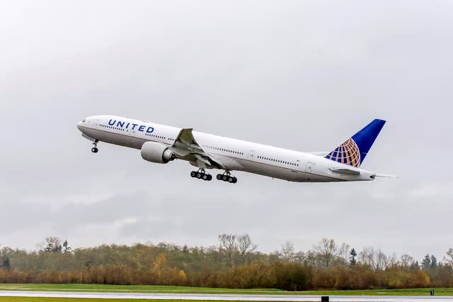 This image shows a Unite Airlines Boeing 777-300ER taking off.