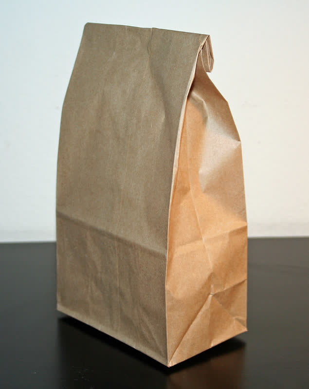 A brown paper bag on a black surface Description automatically generated with medium confidence