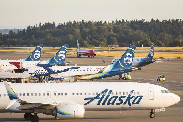 Alaska Airlines planes on the ground at an airport.