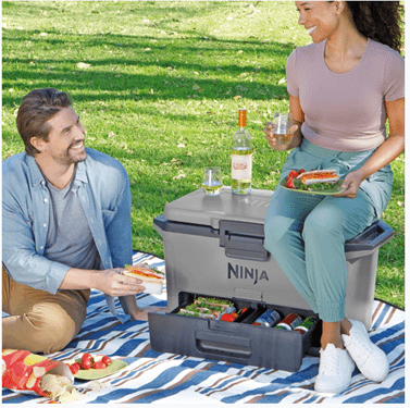Two people sharing a picnic with a SN cooler