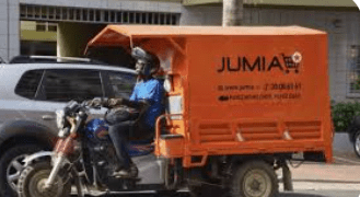 A Jumia logistics staff riding a tricycle