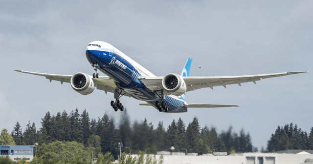 This image shows a Boeing 777-9 airplane taking off.