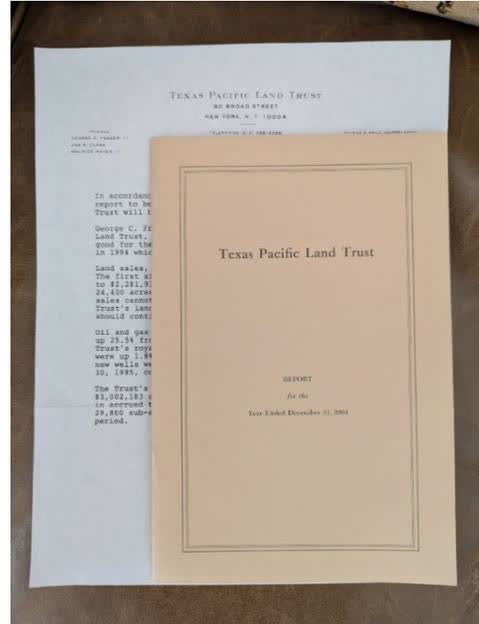 Cover of the Texas Pacific Land Trust annual report for the year ended December 31, 2004. The cover is orange with a white label on top. The label contains the trust's name and address: 1700 Pacific Avenue, Suite 1670, Dallas, Texas 75201. The title 'Texas Pacific Land Trust' is prominently displayed in the center of the cover.