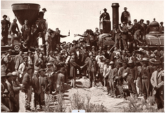 Union Pacific and Central Pacific locomotives meet at Promontory Summit, Utah, on May 10, 1869, as workers and officials celebrate completion of the first transcontinental railroad.